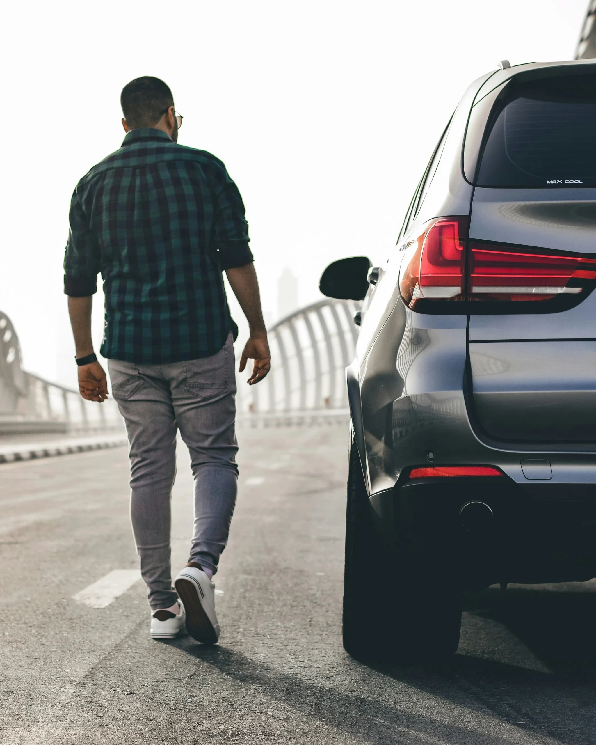 Man approaching a safely delivered BMW SUV — Michigan auto transport and vehicle shipping by Swift Auto Transport