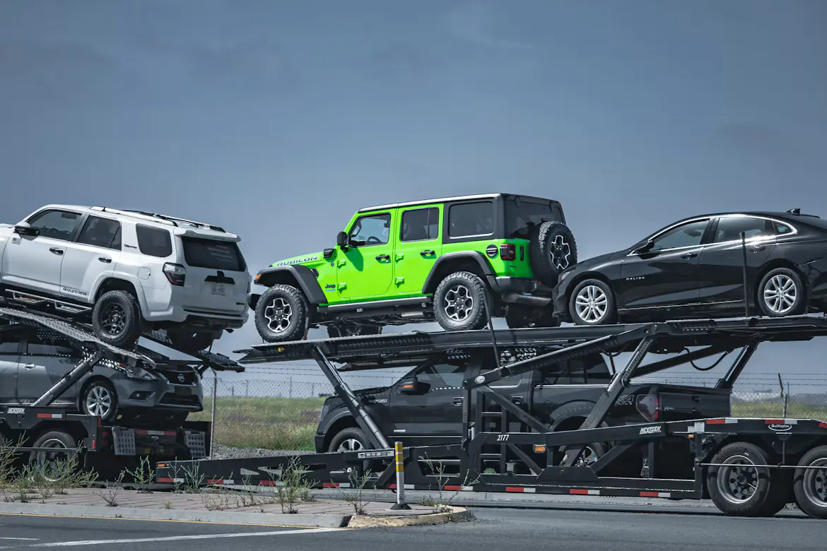 Open carrier transport truck loaded with SUVs and sedans for Michigan auto transport and vehicle shipping